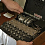 How did the Enigma cipher machine work and is it still in use today?
